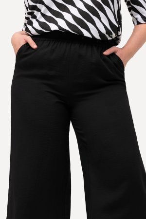 moteriskos juodos placios kelnes